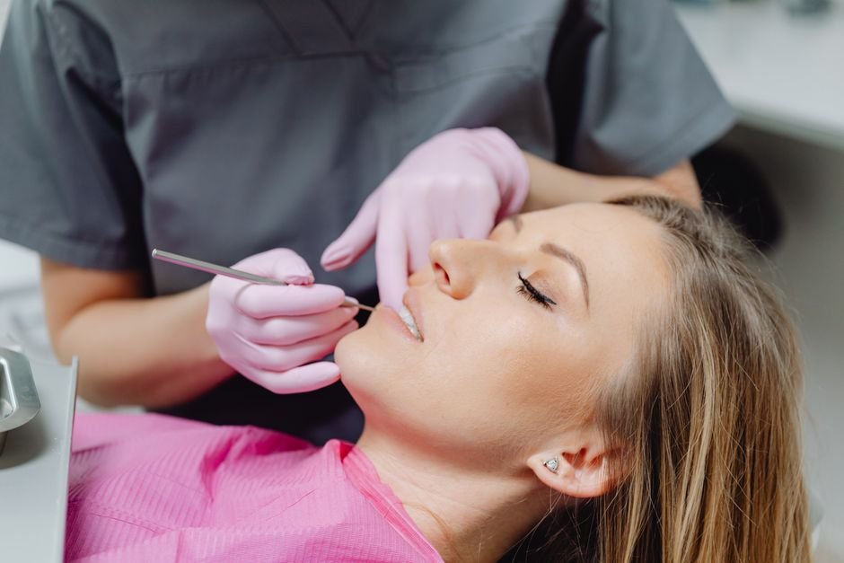 A dentist showing a patient a dental crown model