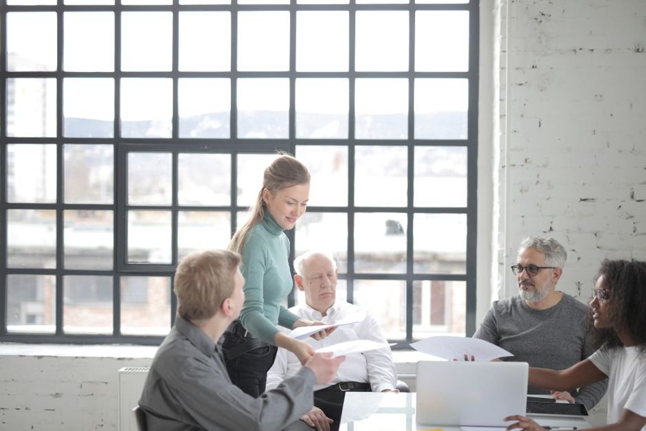 Employee reviewing employer vs individual dental insurance enrollment documents at a desk
