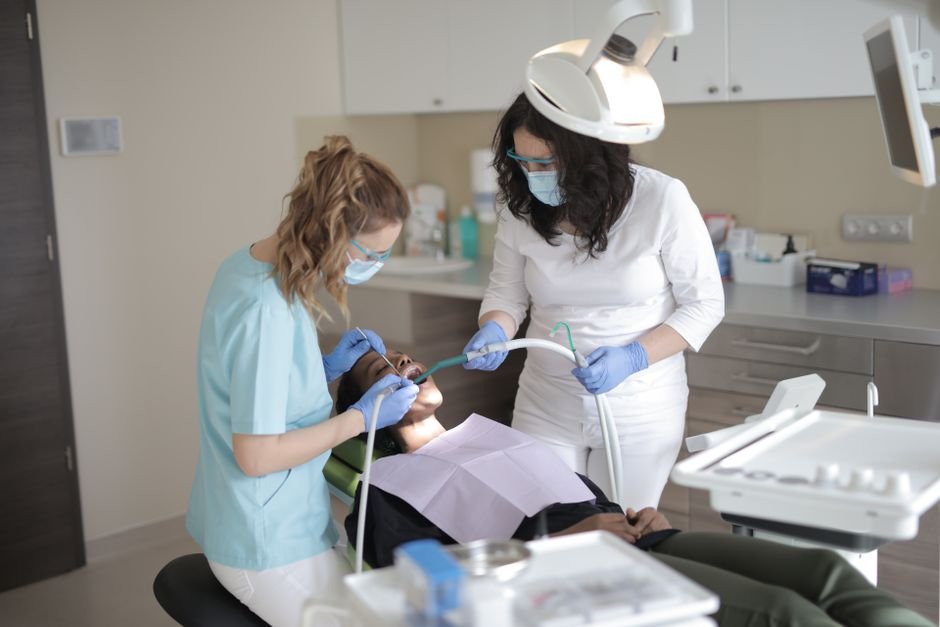 Dentist explaining full coverage dental insurance options to a patient
