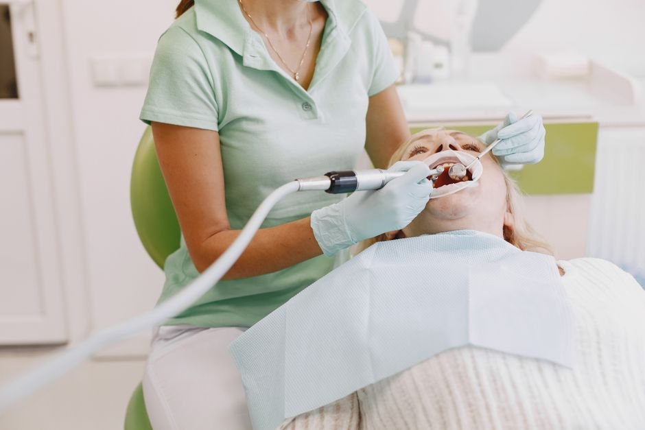 Dental hygienist performing a preventive cleaning covered by dental insurance