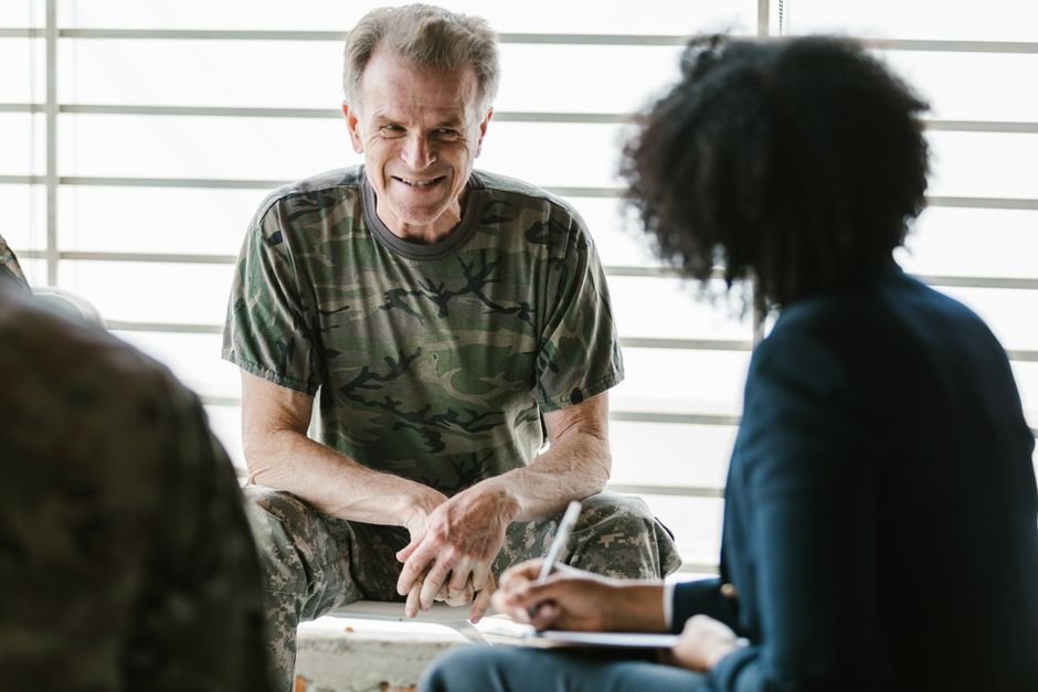 Veteran reviewing dental insurance for veterans options with a healthcare adviser