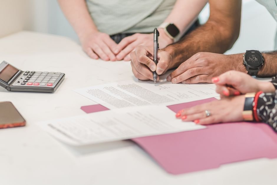 Person reviewing dental insurance annual maximum details in plan paperwork